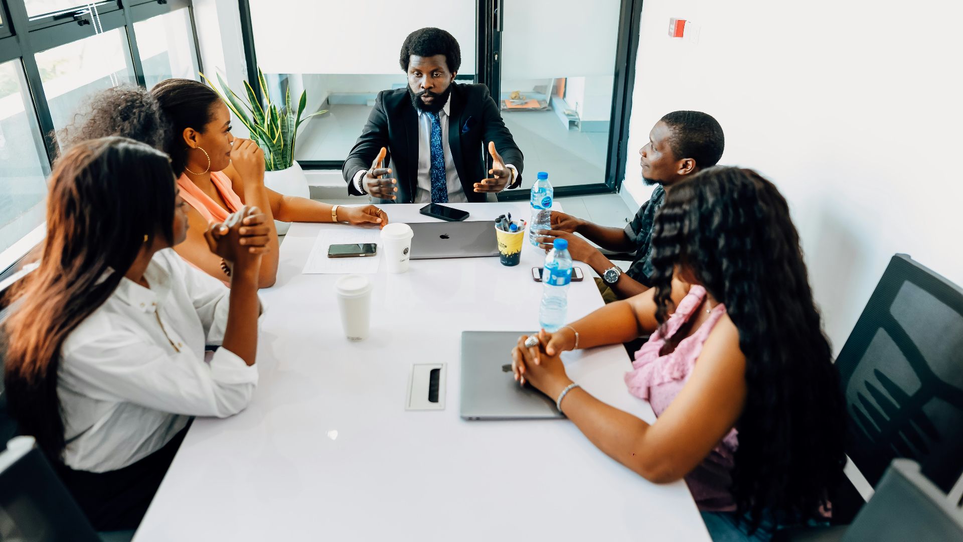 A group of people sitting around a white table
