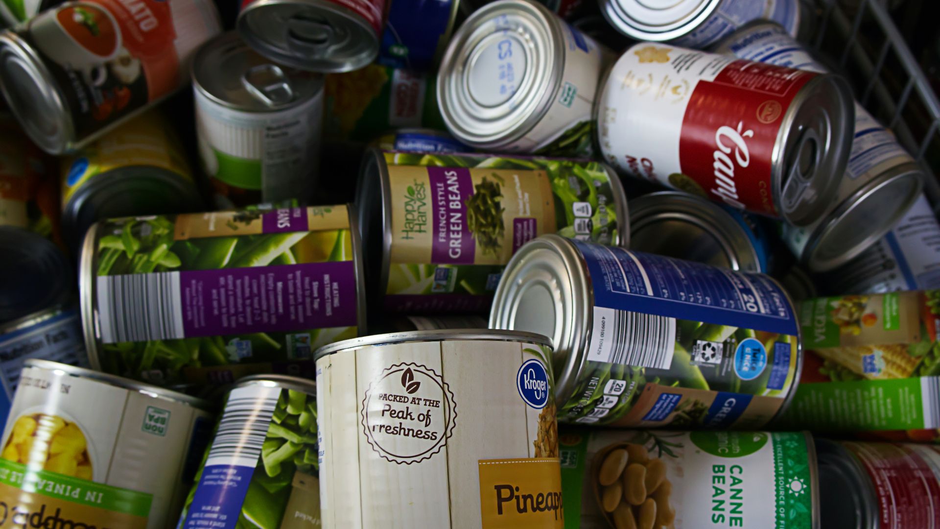 A pile of cans of food sitting next to each other
