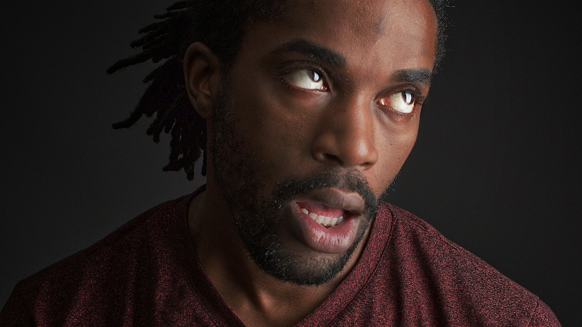 man opening his mouth and looking up