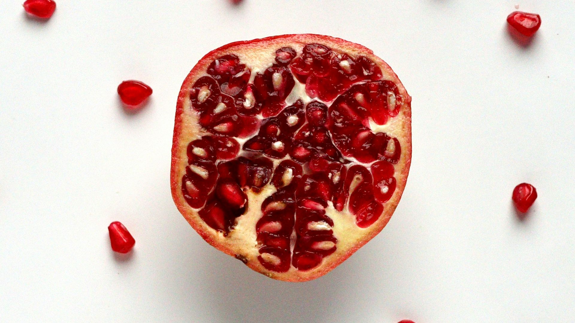 red sliced fruit on white surface