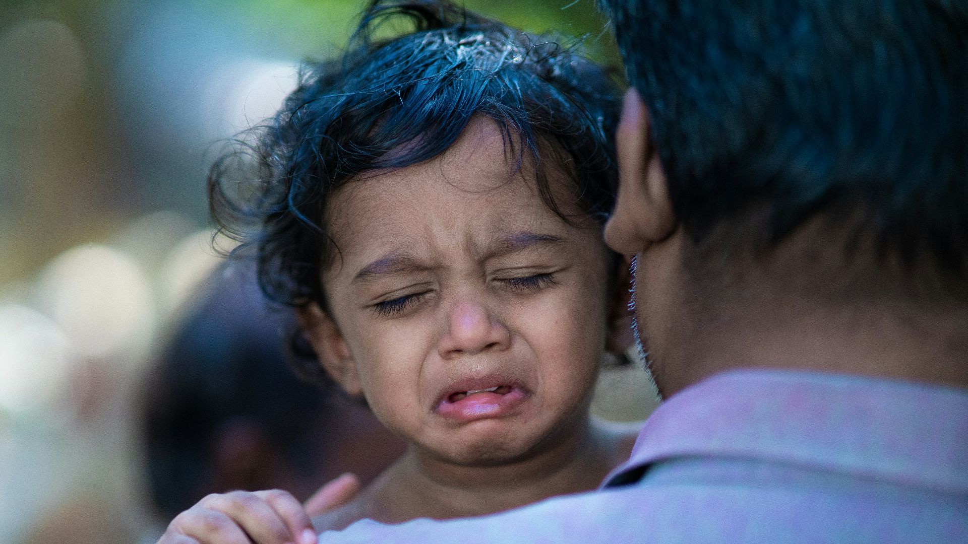 a woman holding a child with a surprised look on her face