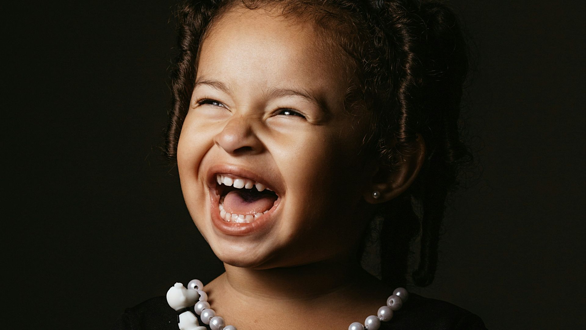 girl in black crew neck t-shirt smiling