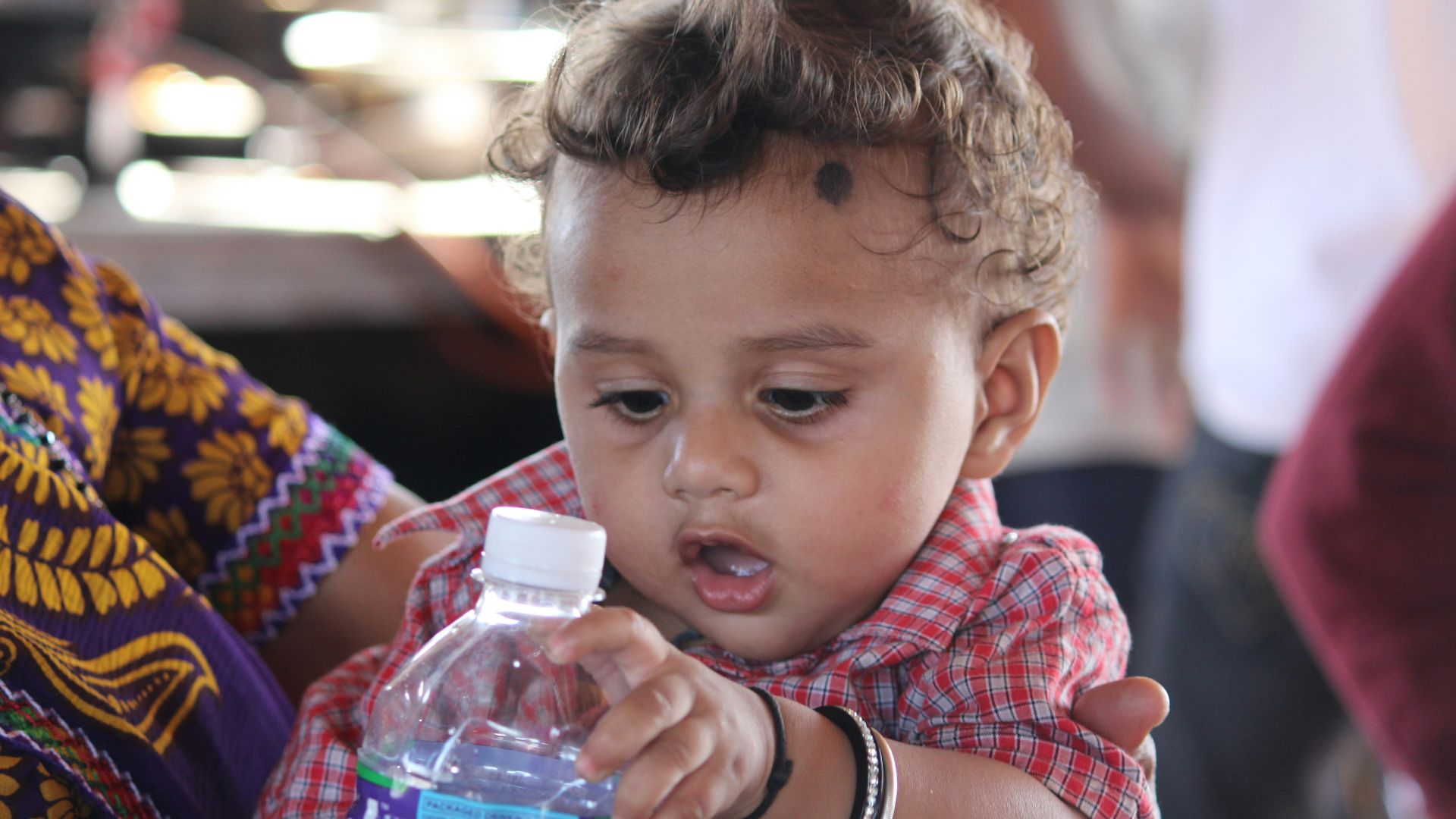 a baby holding a bottle
