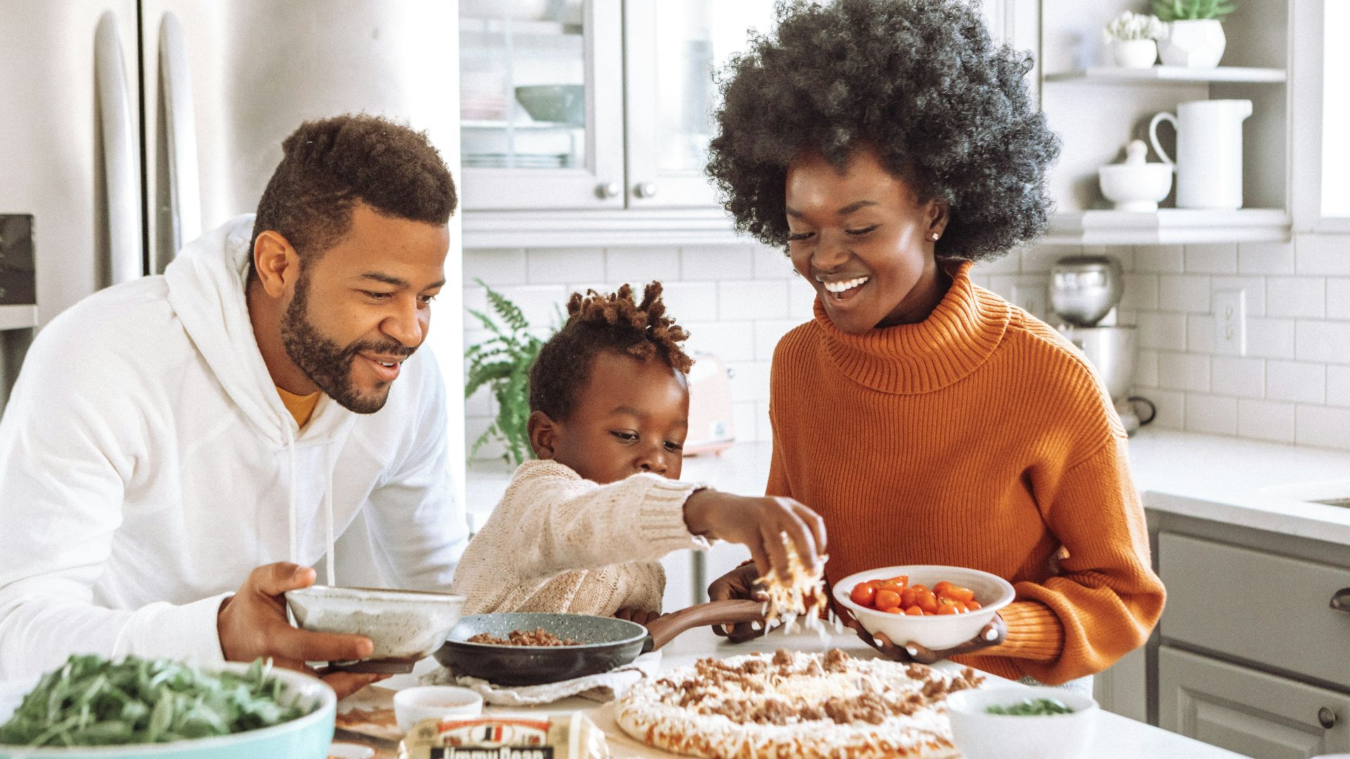 man in white dress shirt holding a girl in white dress