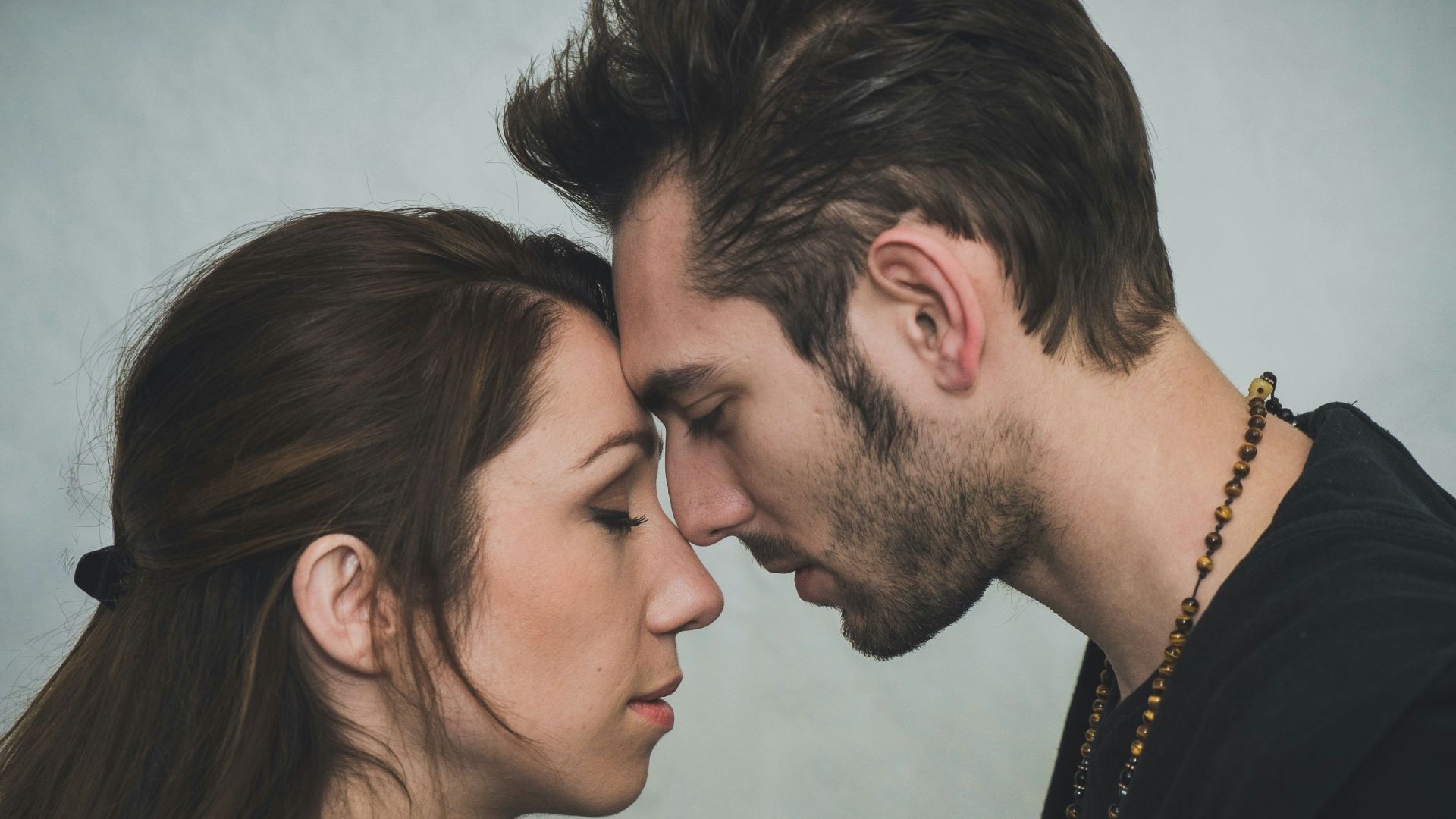 man and woman kissing each other