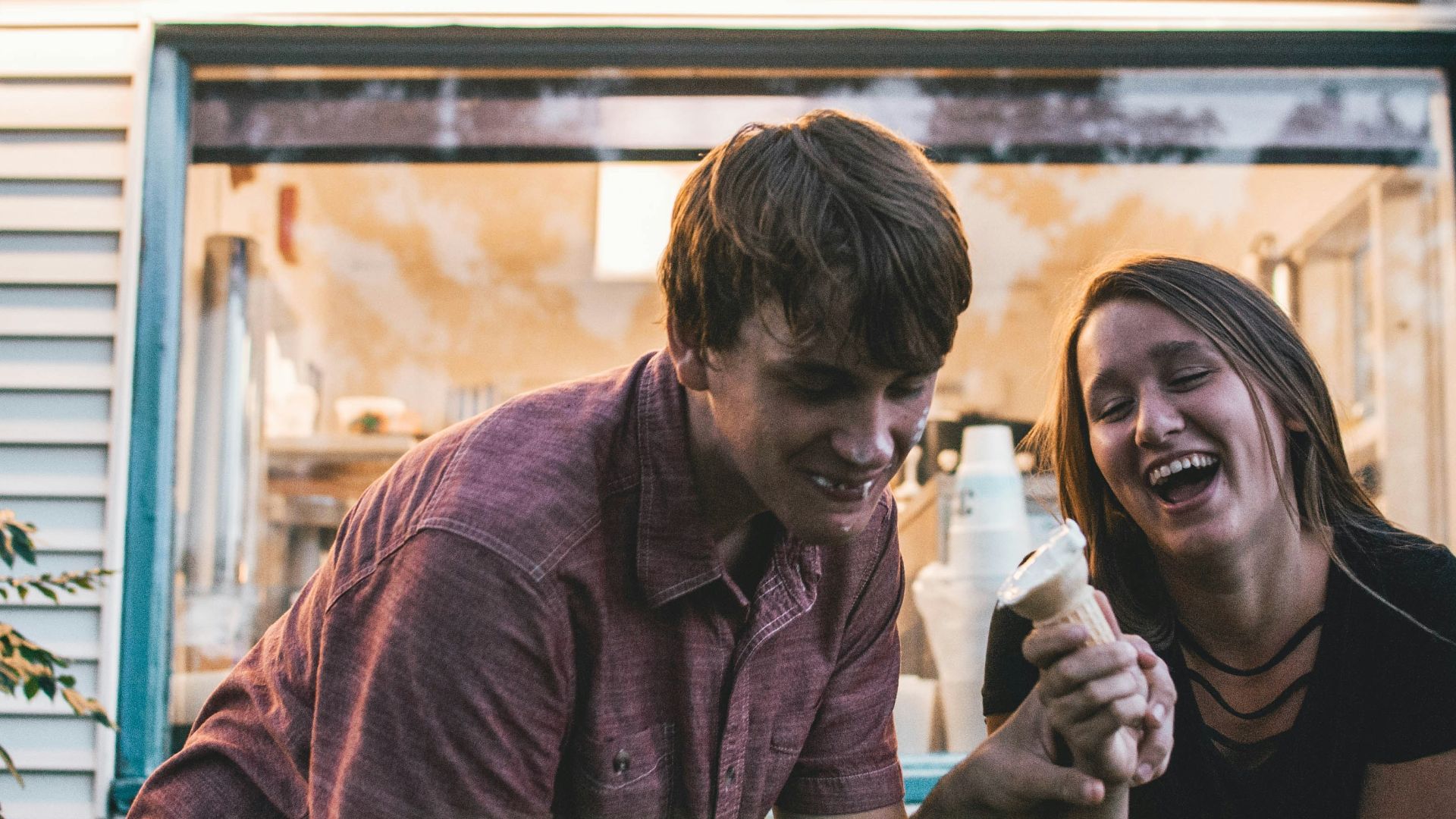 man and woman eating ice cream during daytime