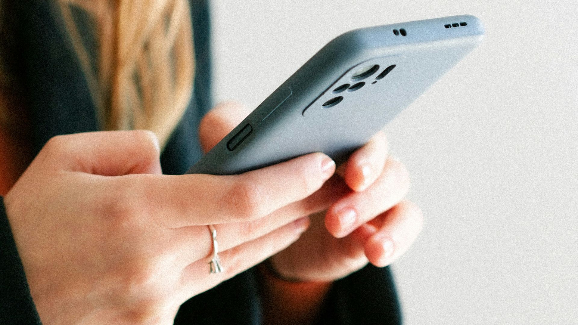 a woman holding a cell phone in her hands