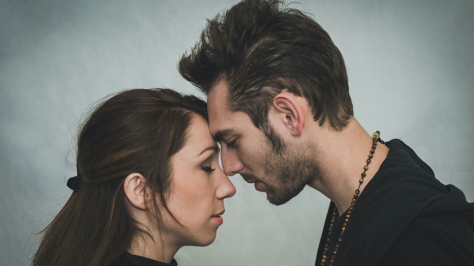 man and woman kissing each other