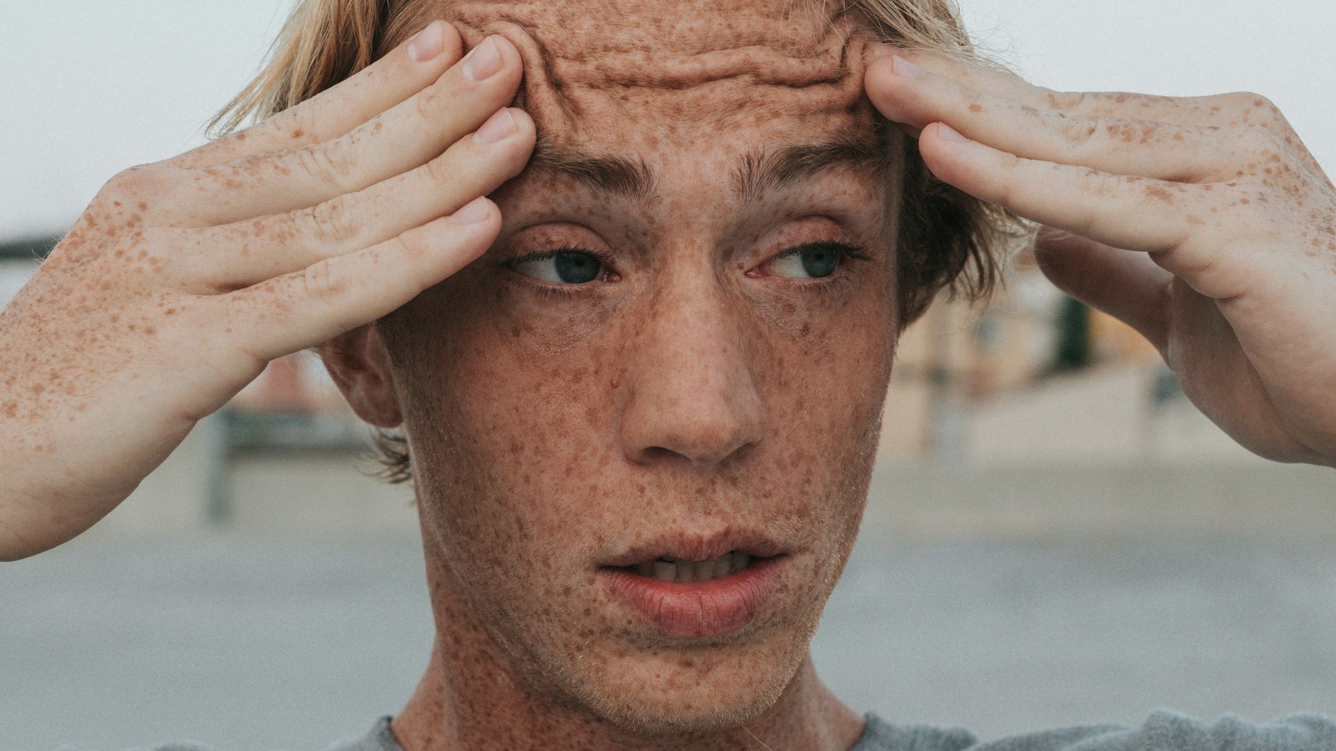 man in gray crew neck shirt with brown hair