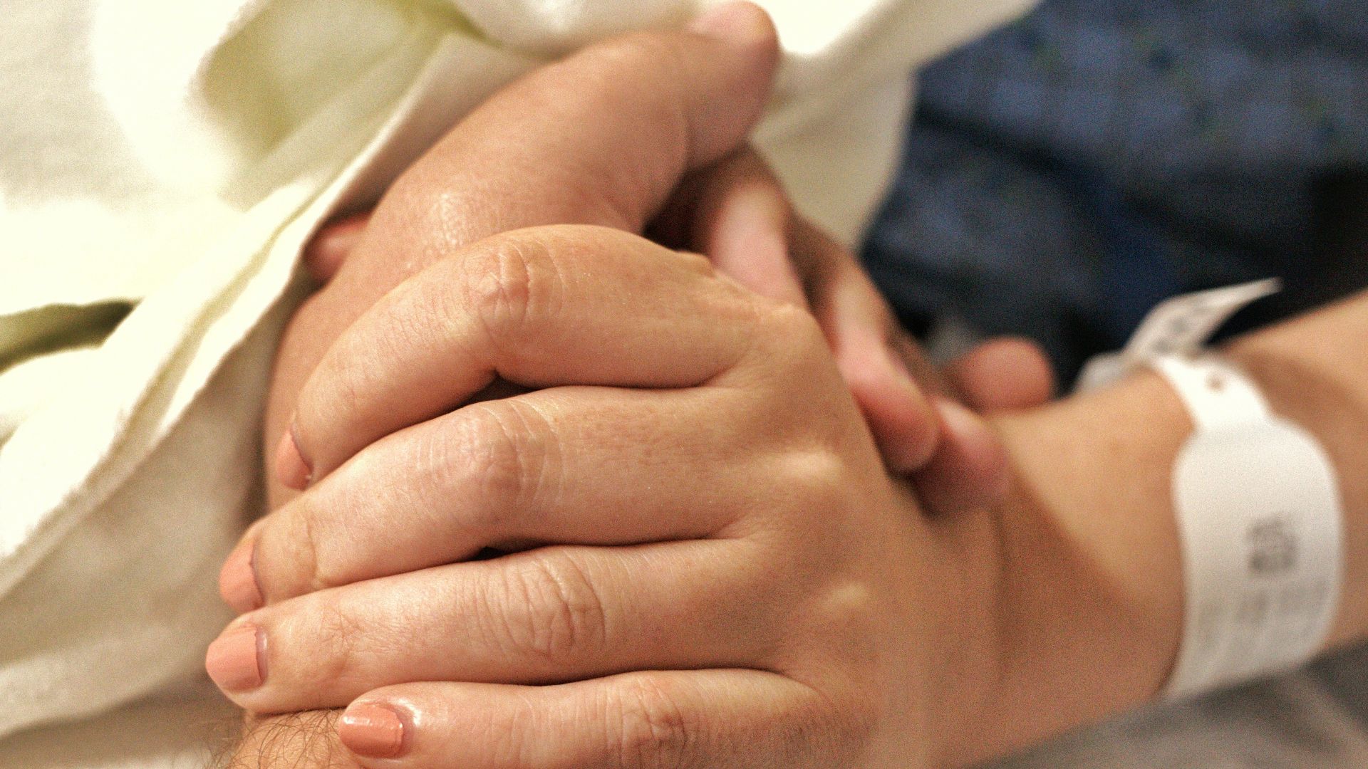 a close up of a person holding the hand of another person