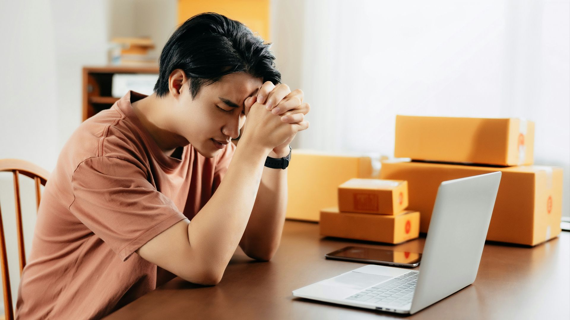 a man sitting in front of a laptop computer