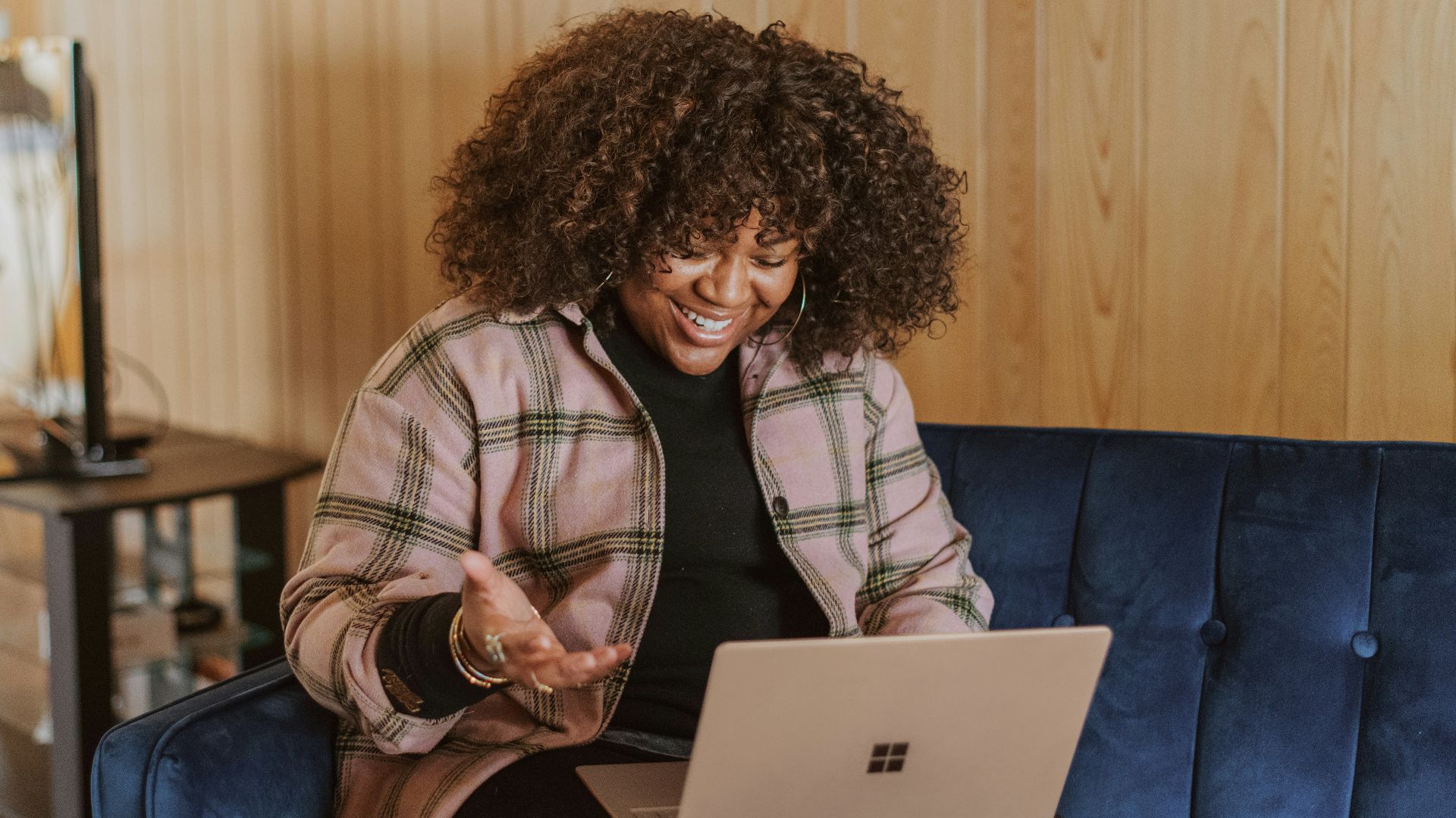 person sitting on couch holding a Surface device