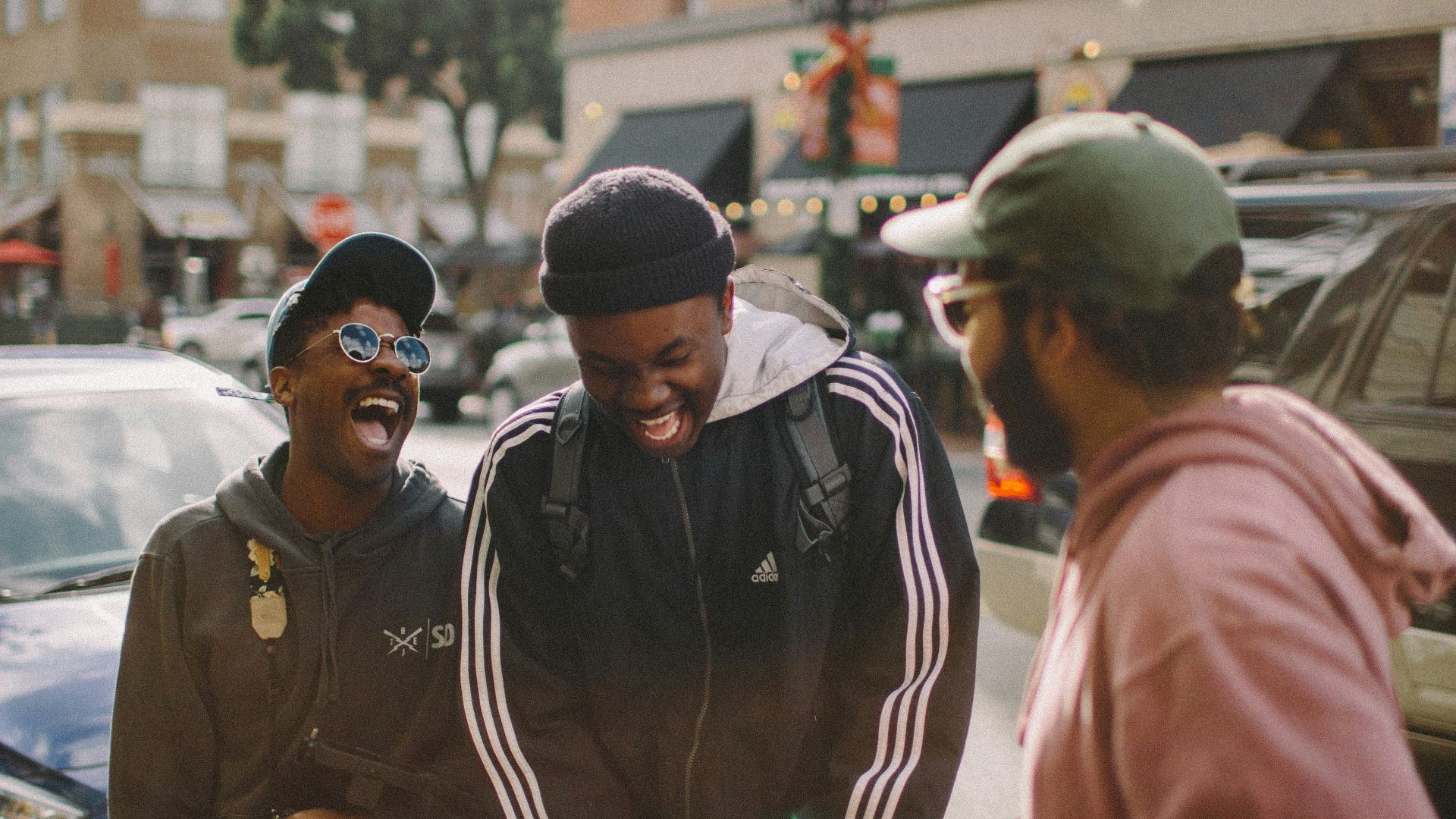 three men in jacket laughing at each other