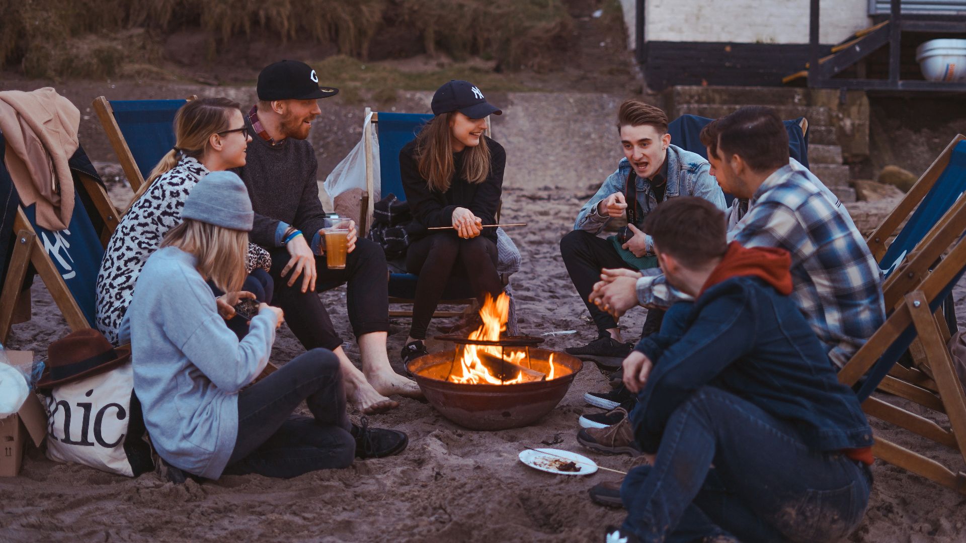 group of people sitting on front firepit
