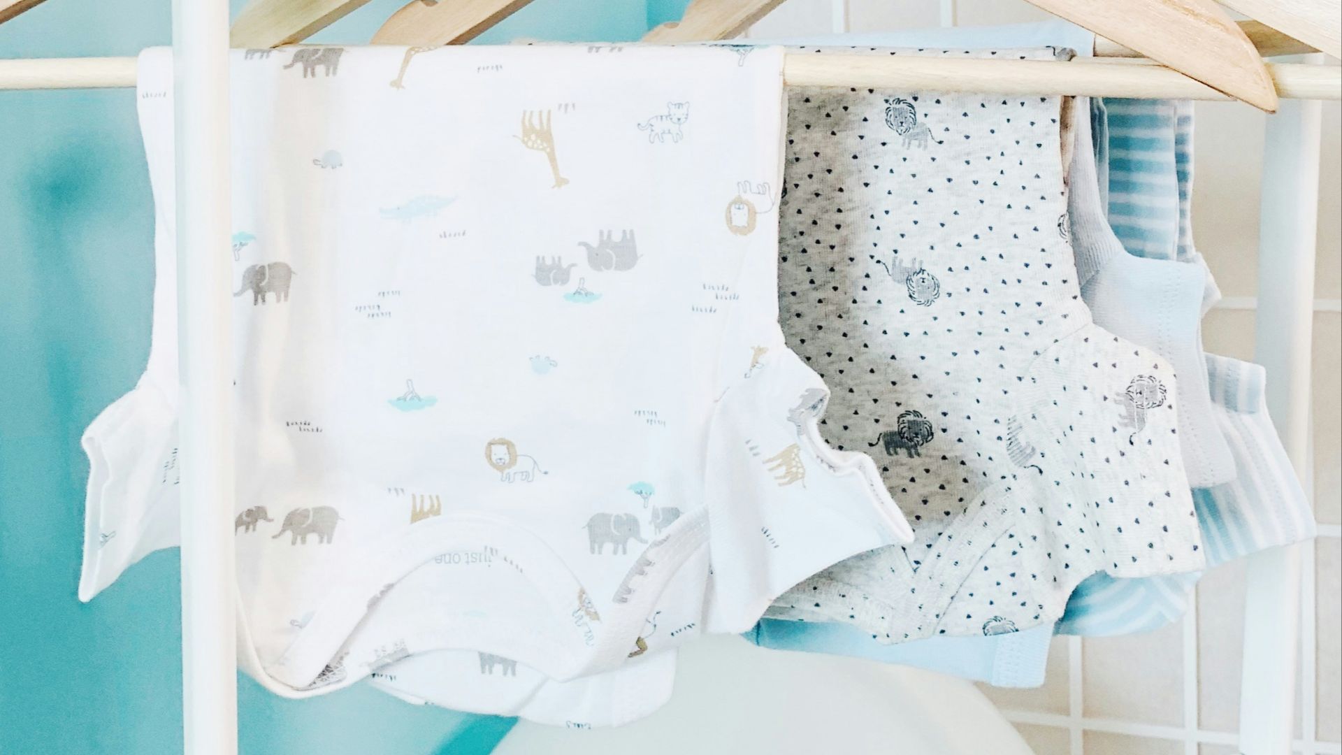 three baby's assorted-color onesies