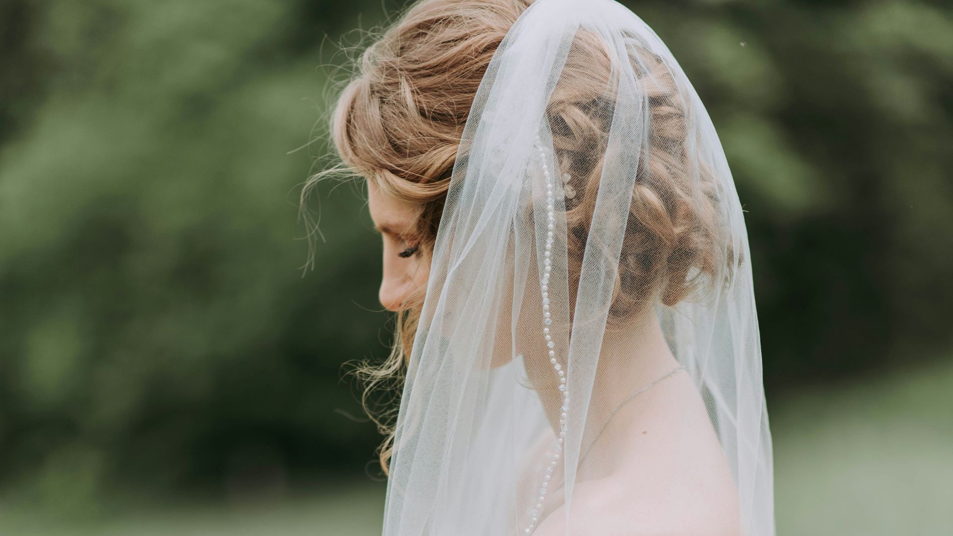 woman wearing white wedding dress with veil