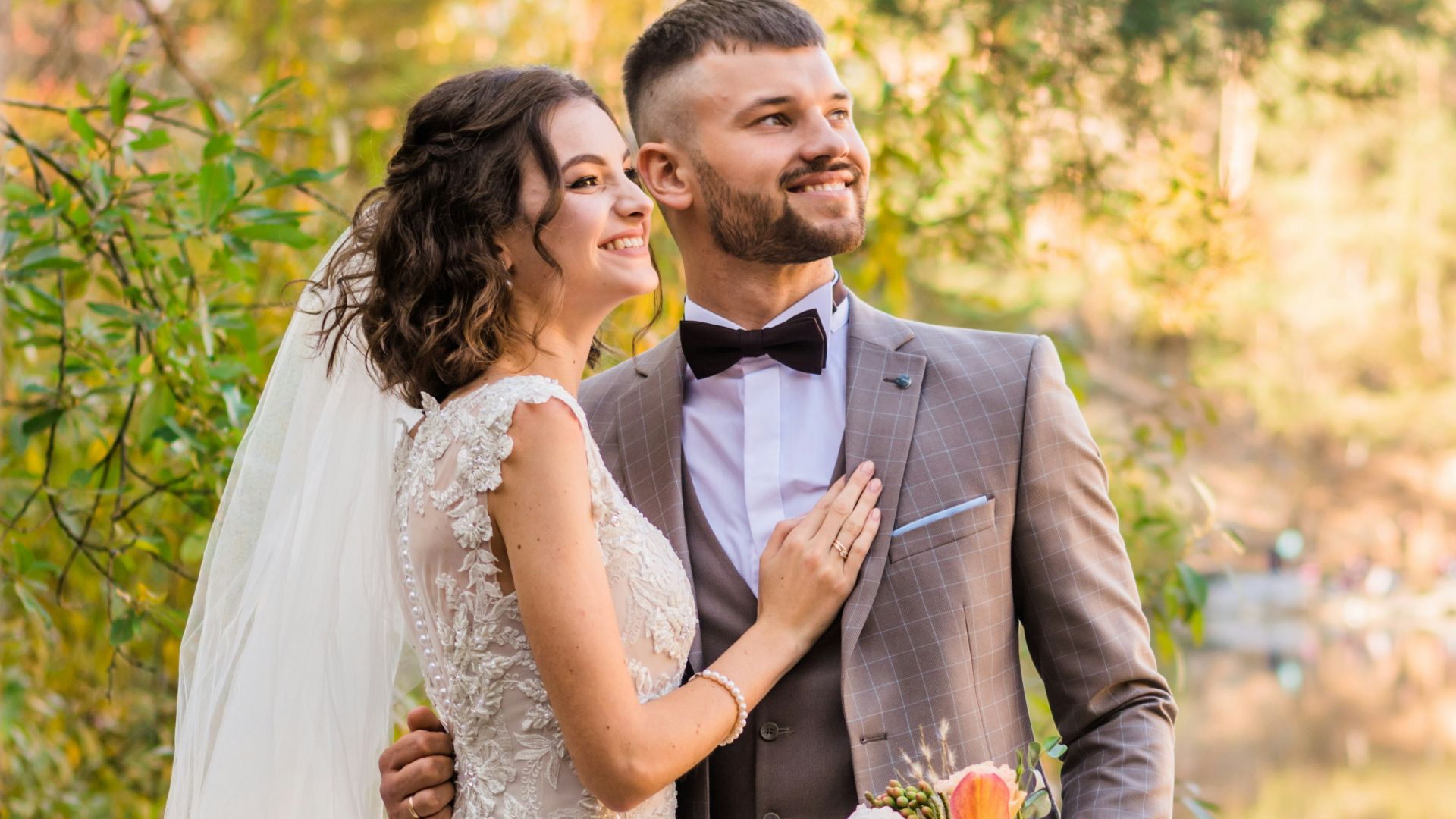man in gray suit and woman in white wedding dress