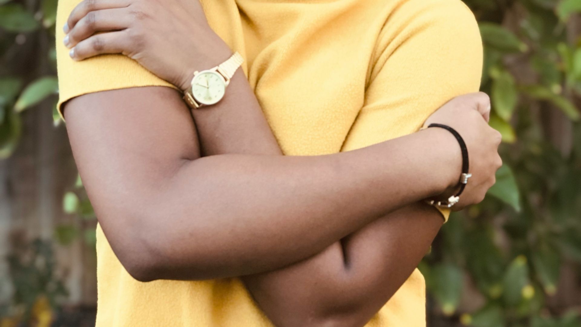 woman in yellow shirt holding yellow fruit