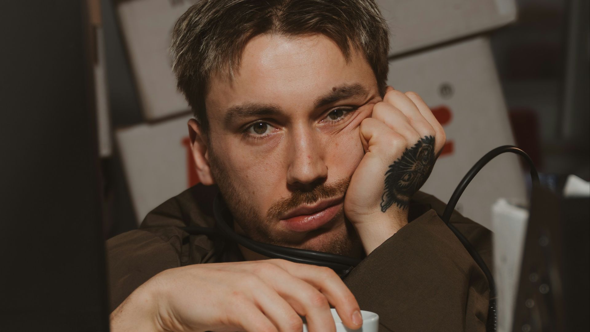 Man is bored and holding a coffee cup.