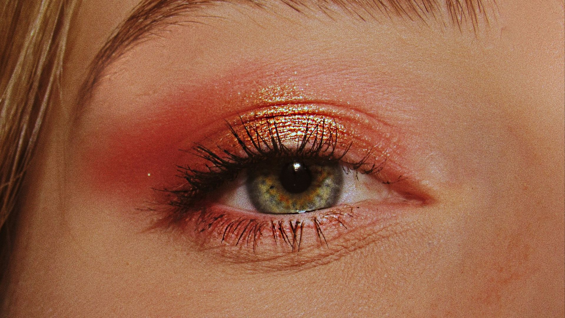 woman with pink and gold eyeshadow makeup