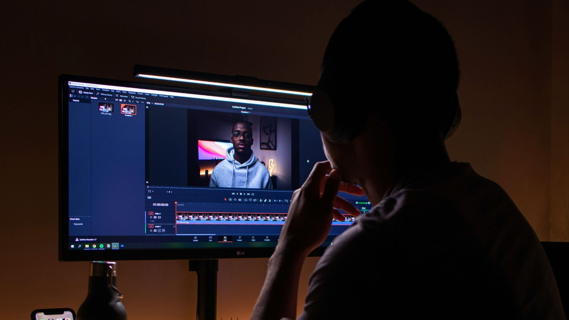 boy in black long sleeve shirt sitting on chair in front of black flat screen tv