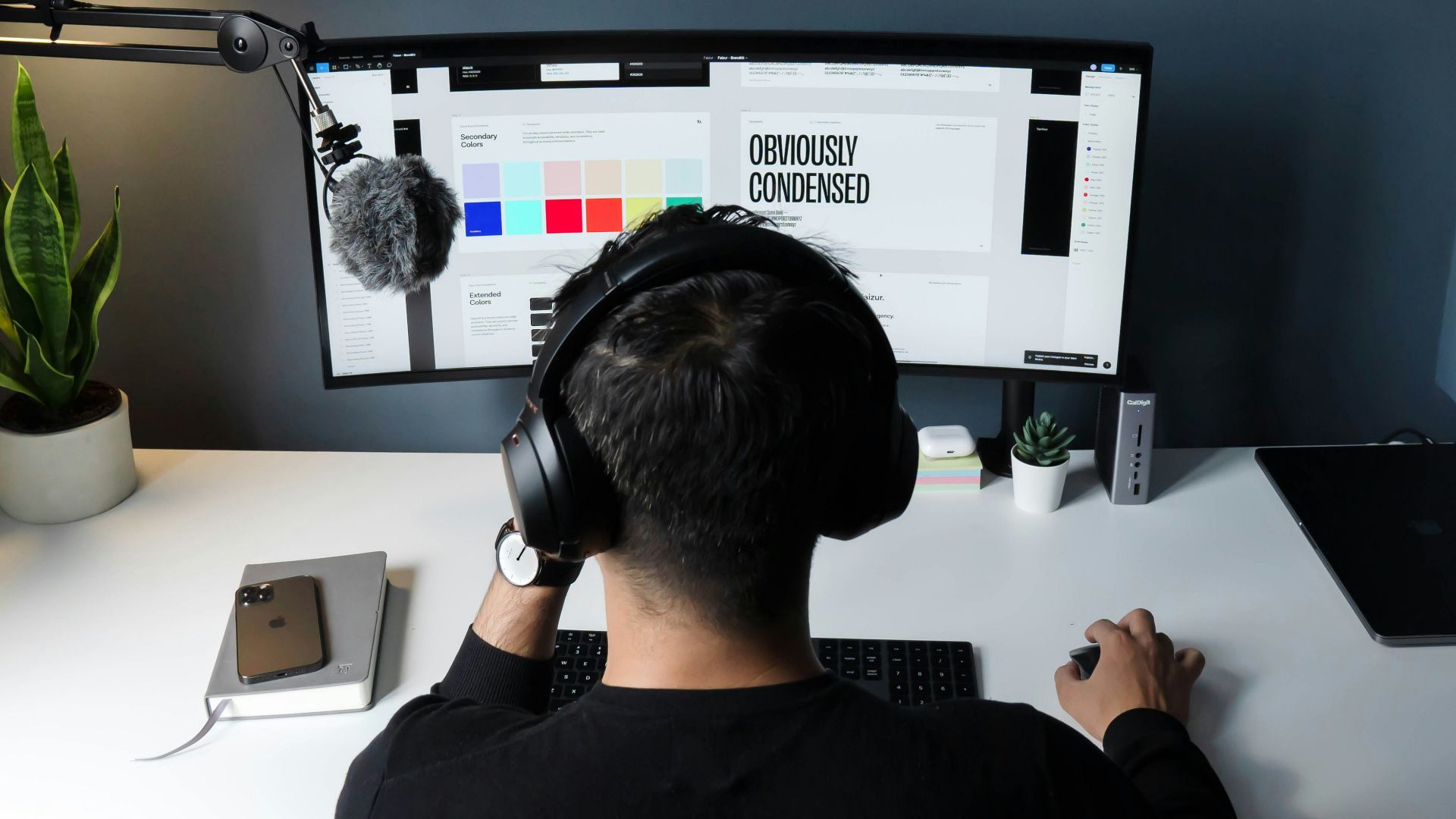 man in black shirt sitting in front of computer