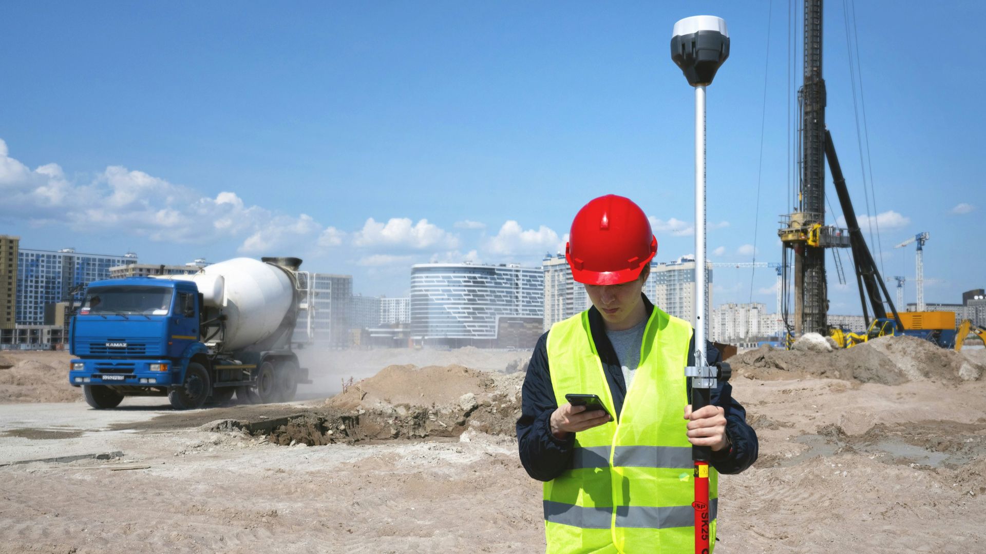 man in black and yellow jacket wearing red helmet holding black and white stick