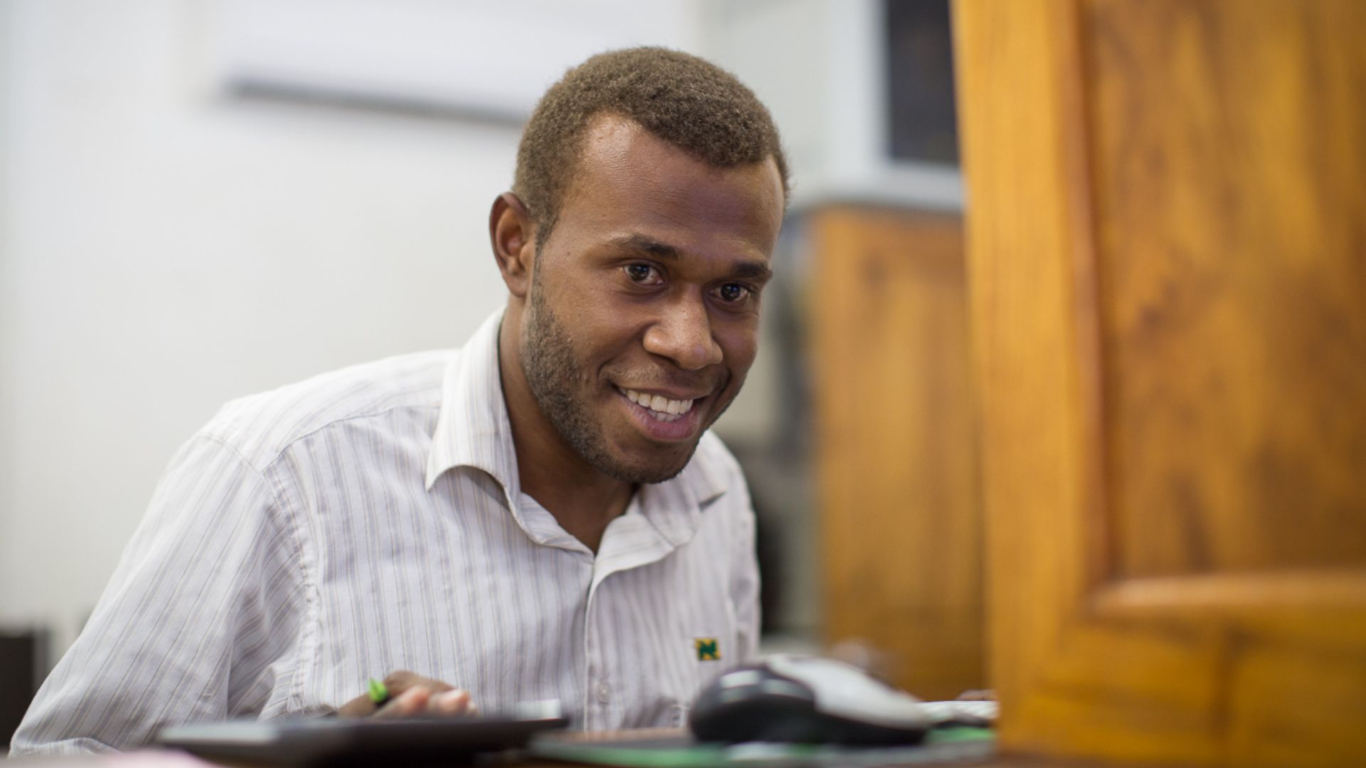 File:A bank teller serves a man at National Bank of Vanuatu on Malekula island. (10661217924).jpg