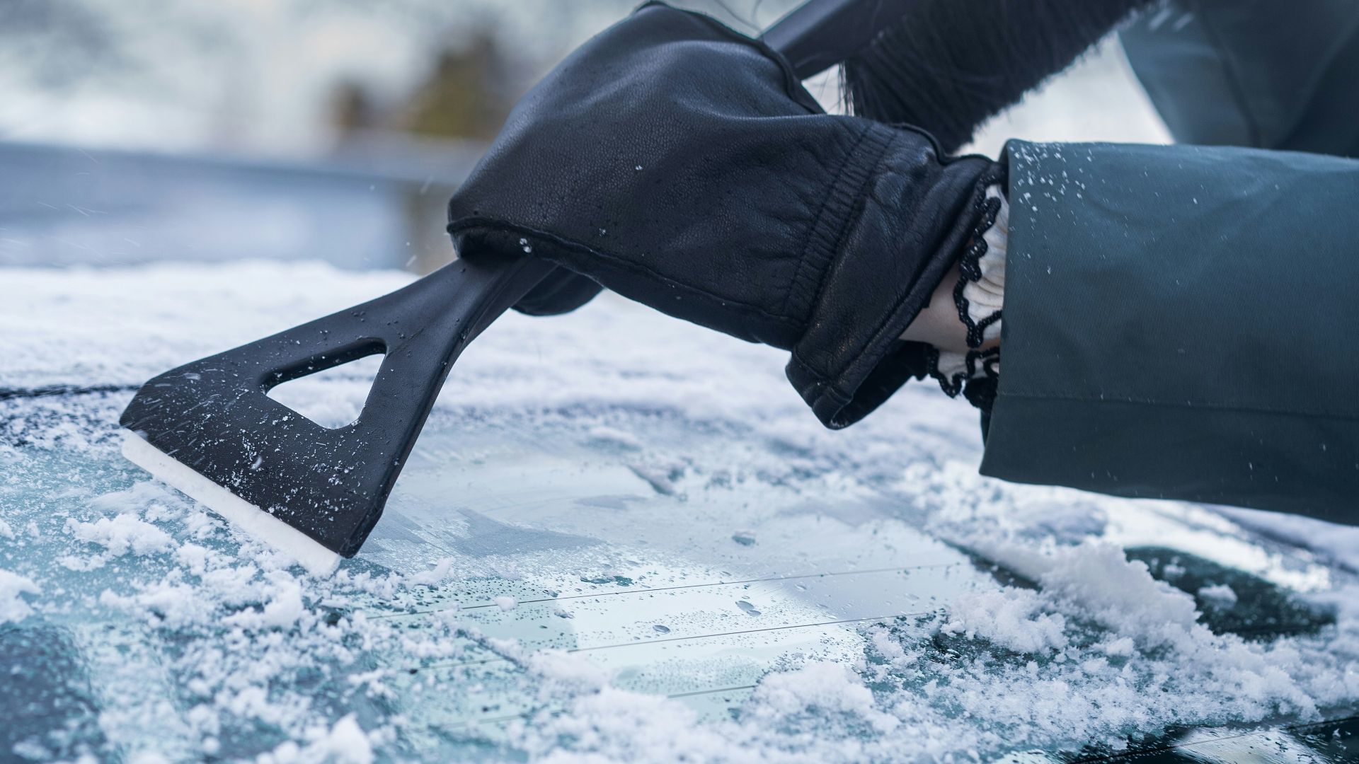 A person with a snowboard on top of a car