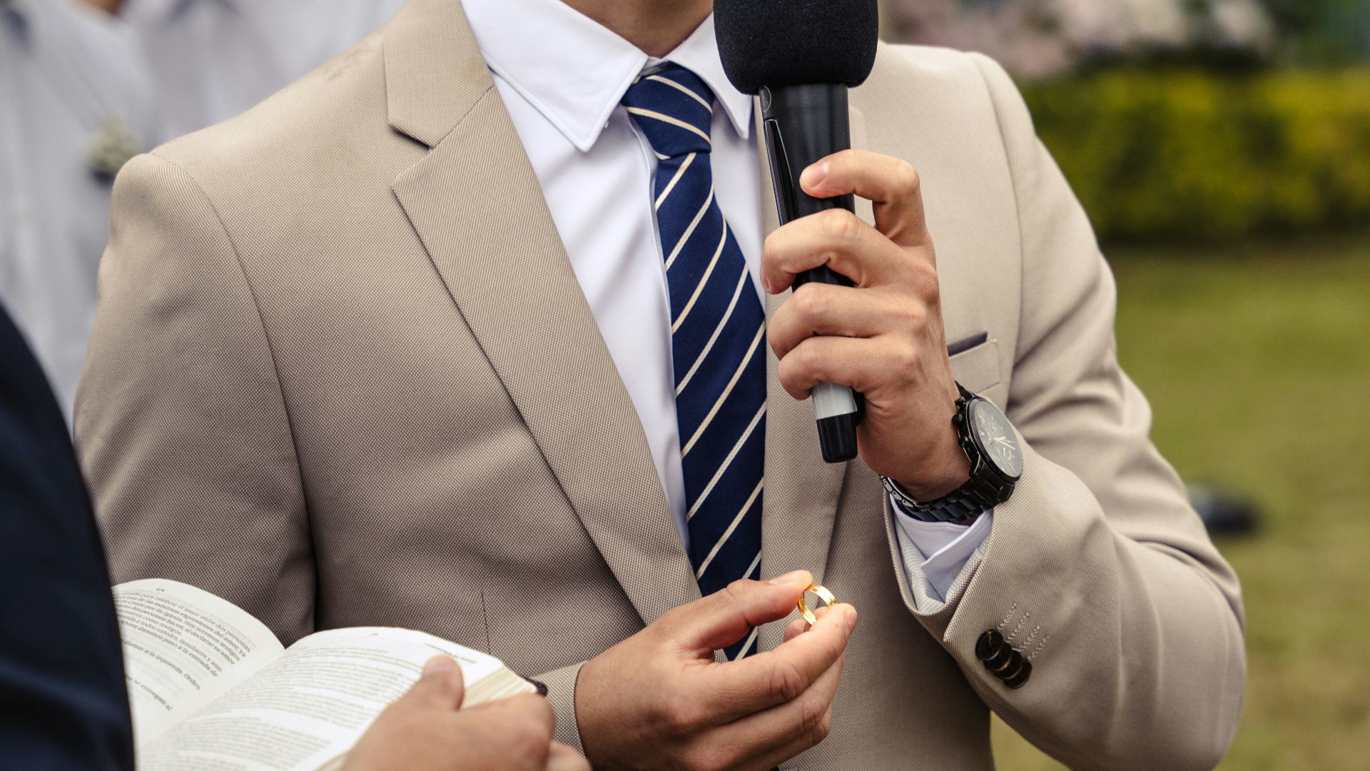 a man in a suit holding a microphone