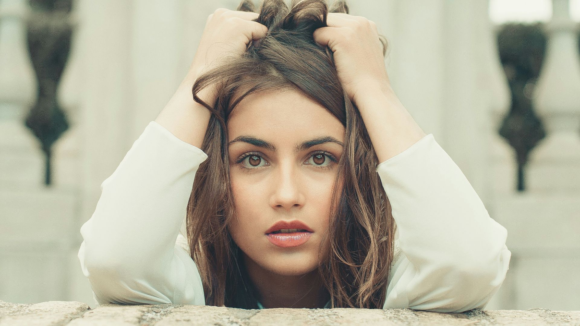 woman in white long sleeve shirt lying on bed