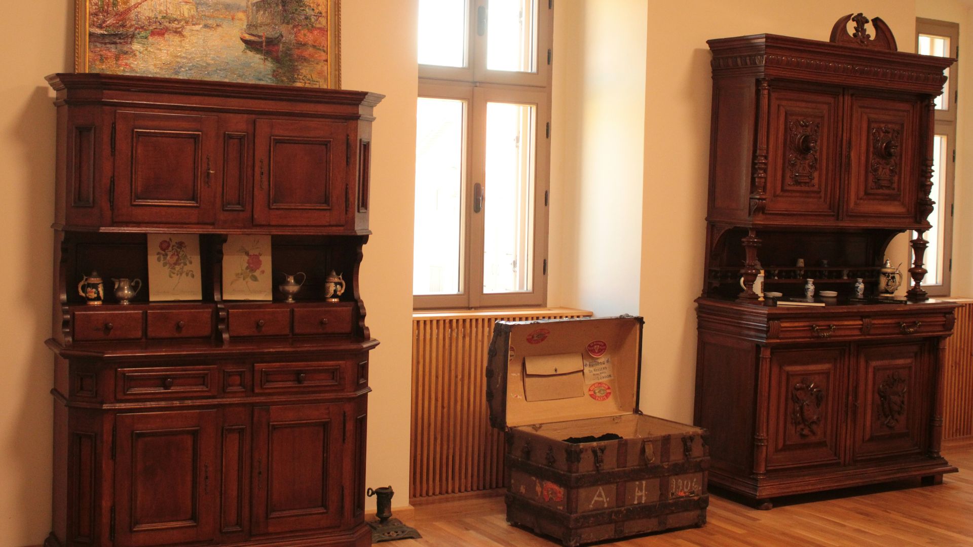 a room with wooden furniture and a painting on the wall