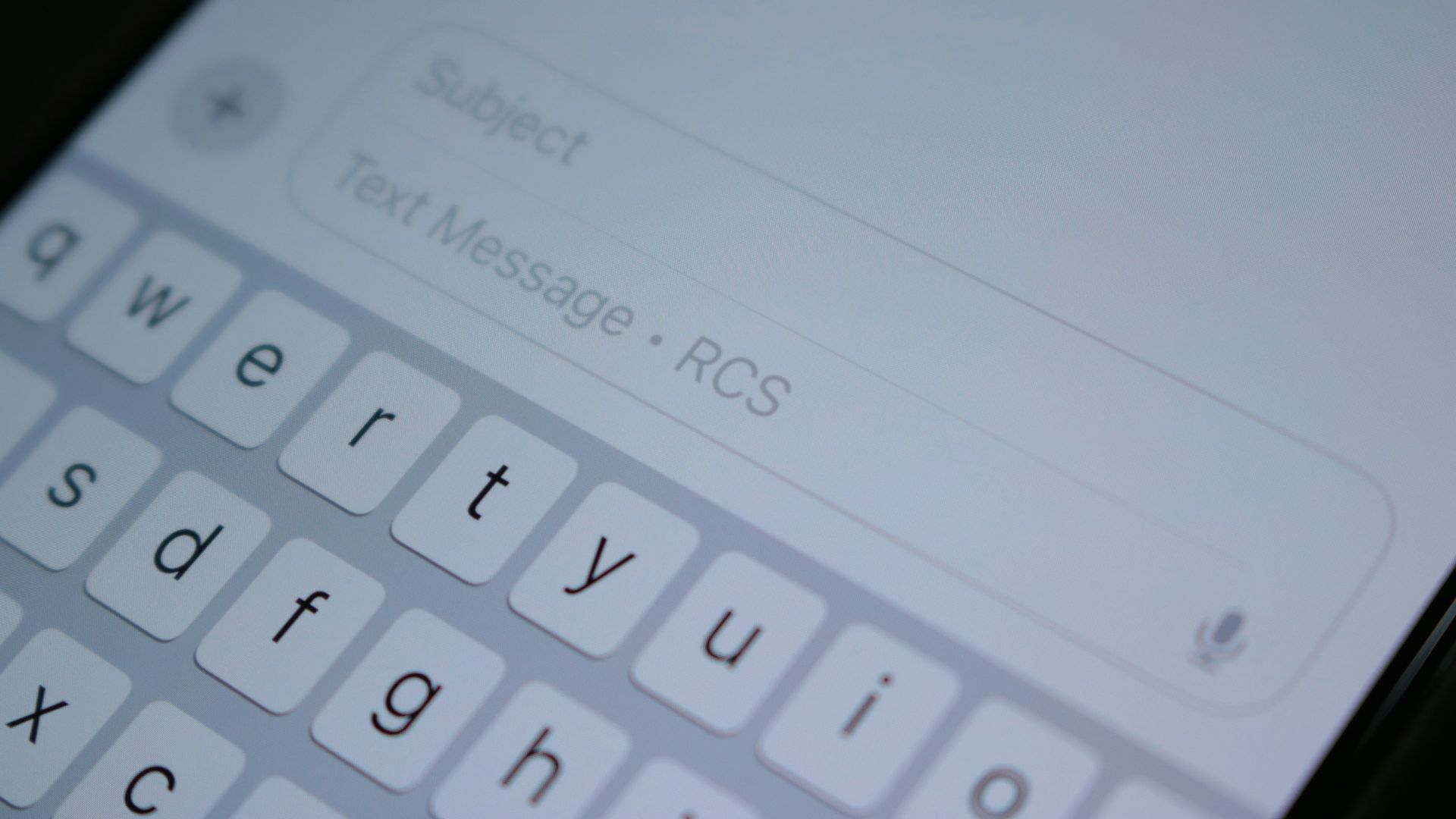 A close up of a cell phone with a keyboard