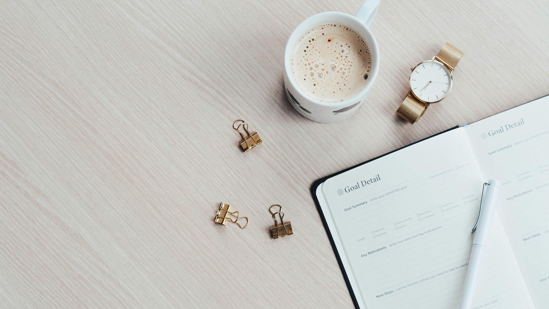 white printer paper beside filled mug