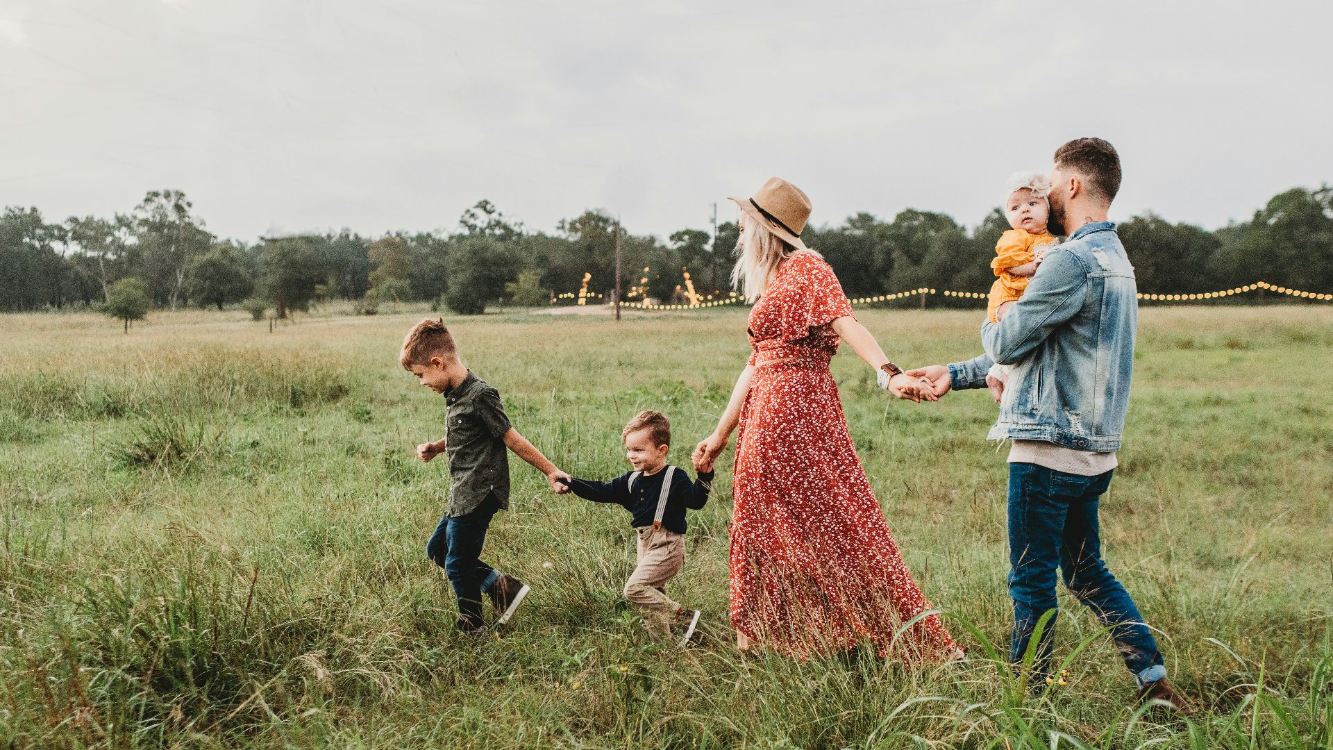 woman holding man and toddler hands during daytime