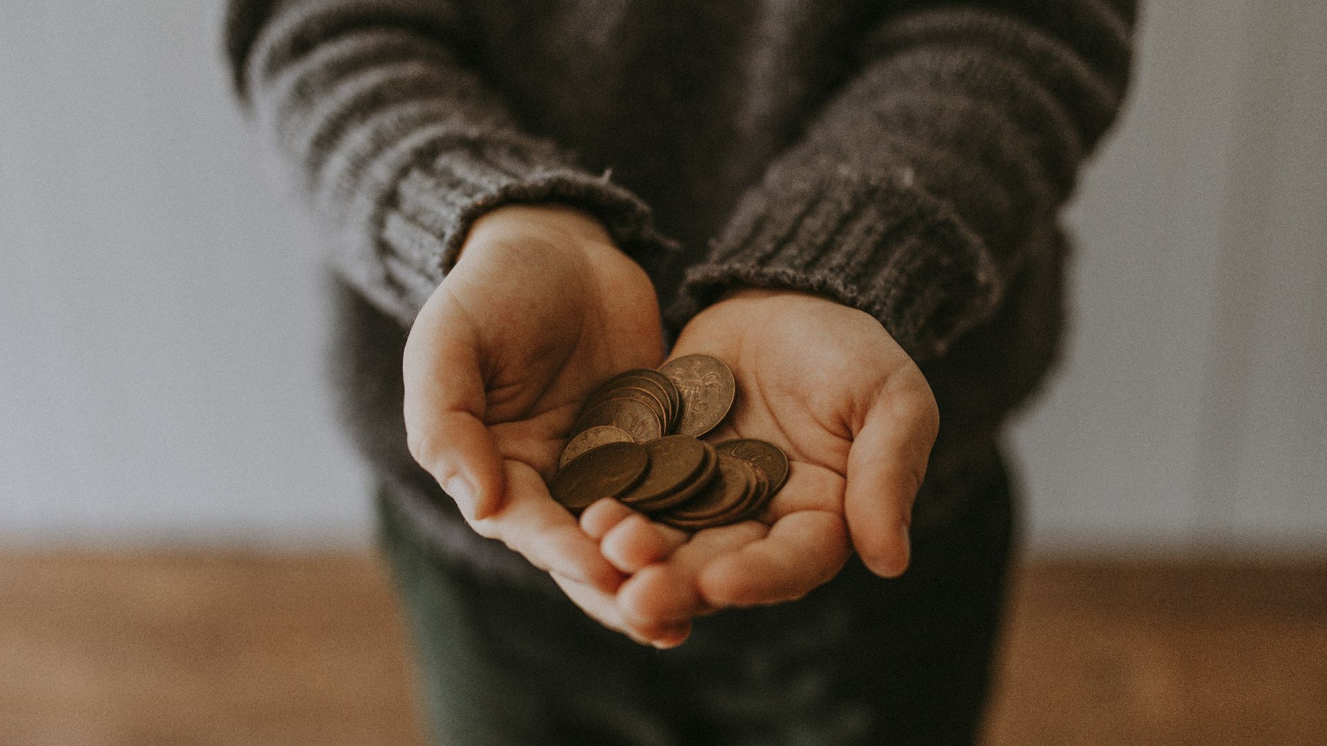 copper-colored coins on in person's hands