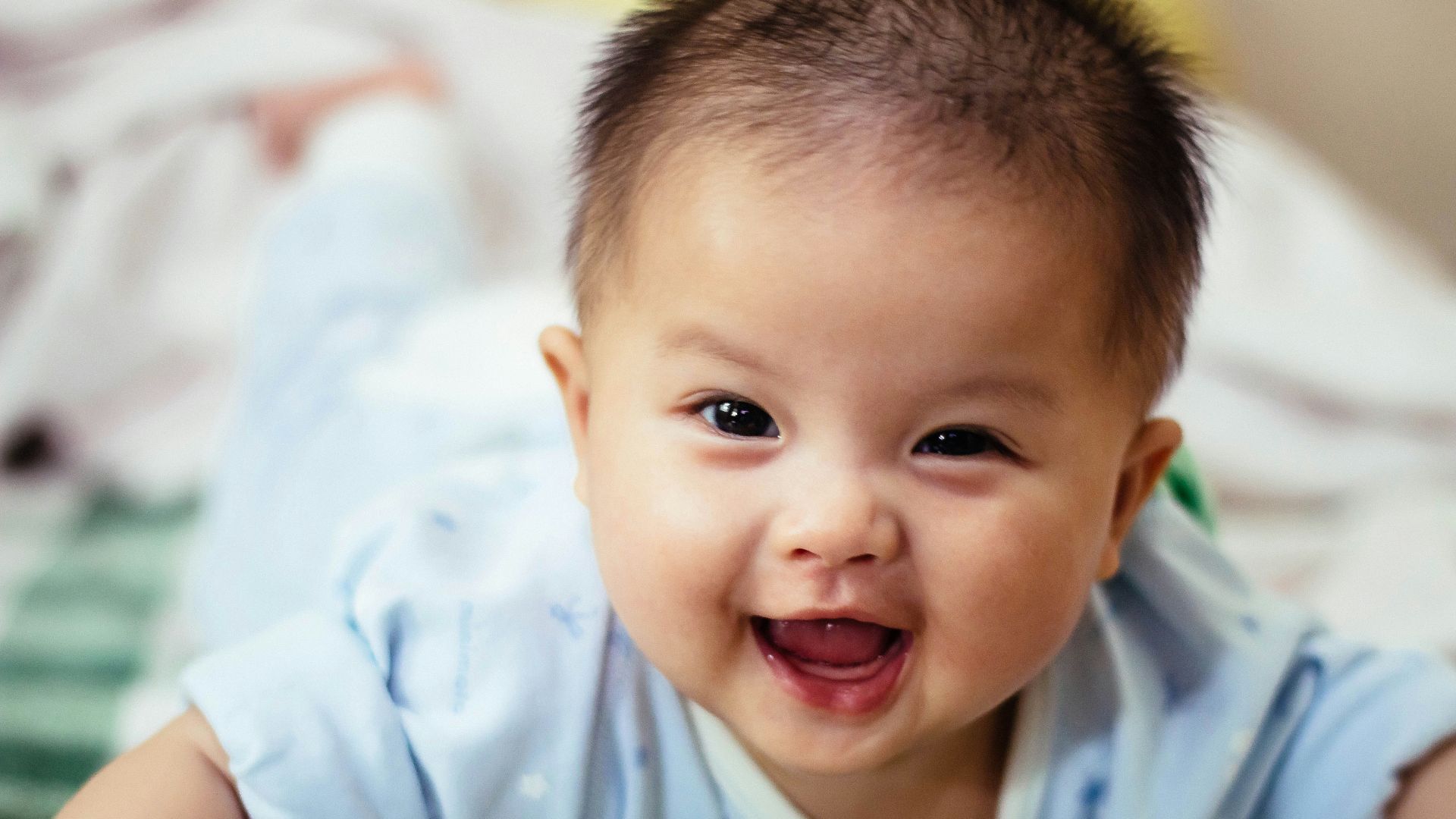 baby smiling and lying forward