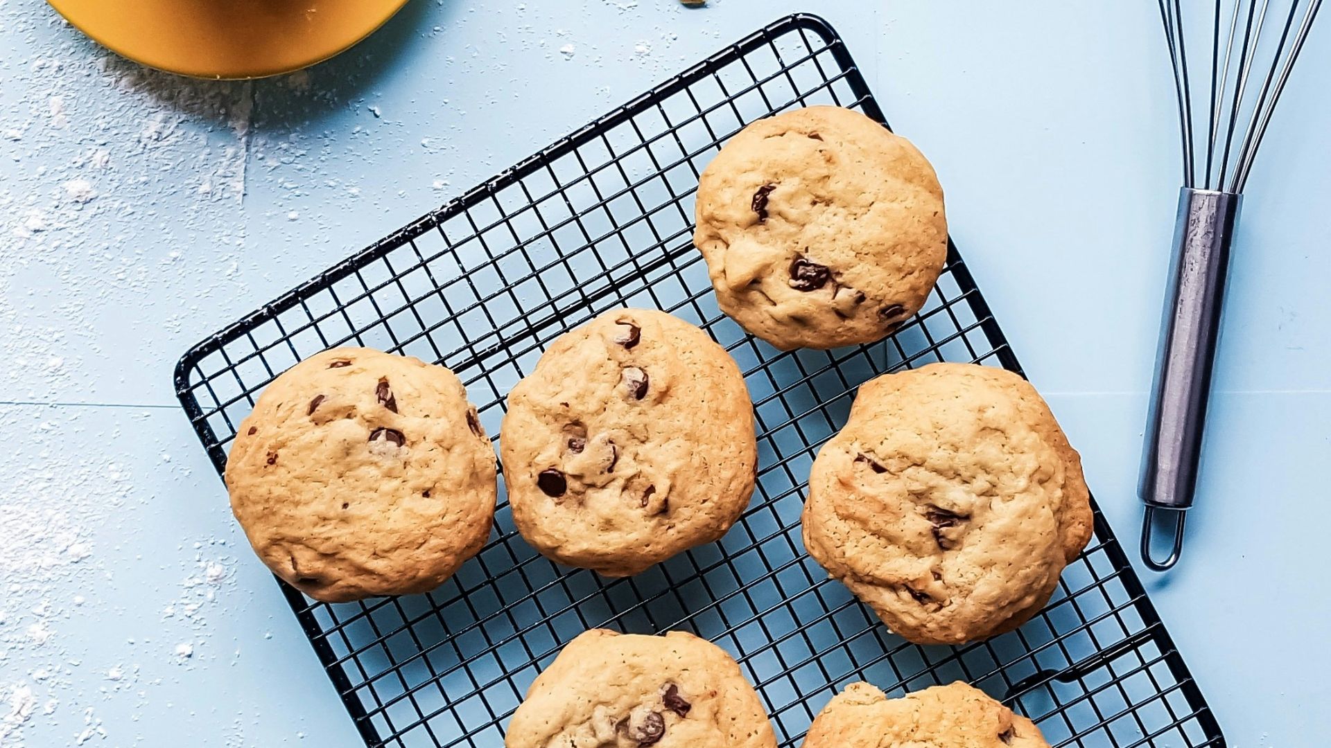 cookies on black grill beside yellow ceramic cup