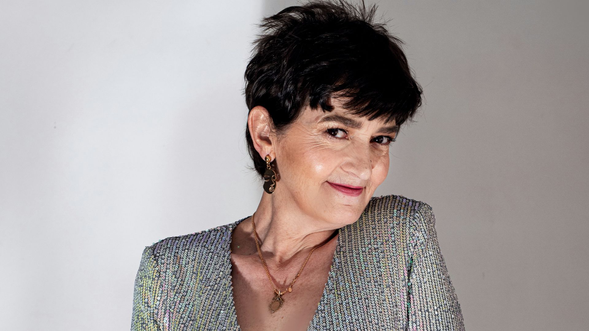 a woman in a silver dress posing for a picture