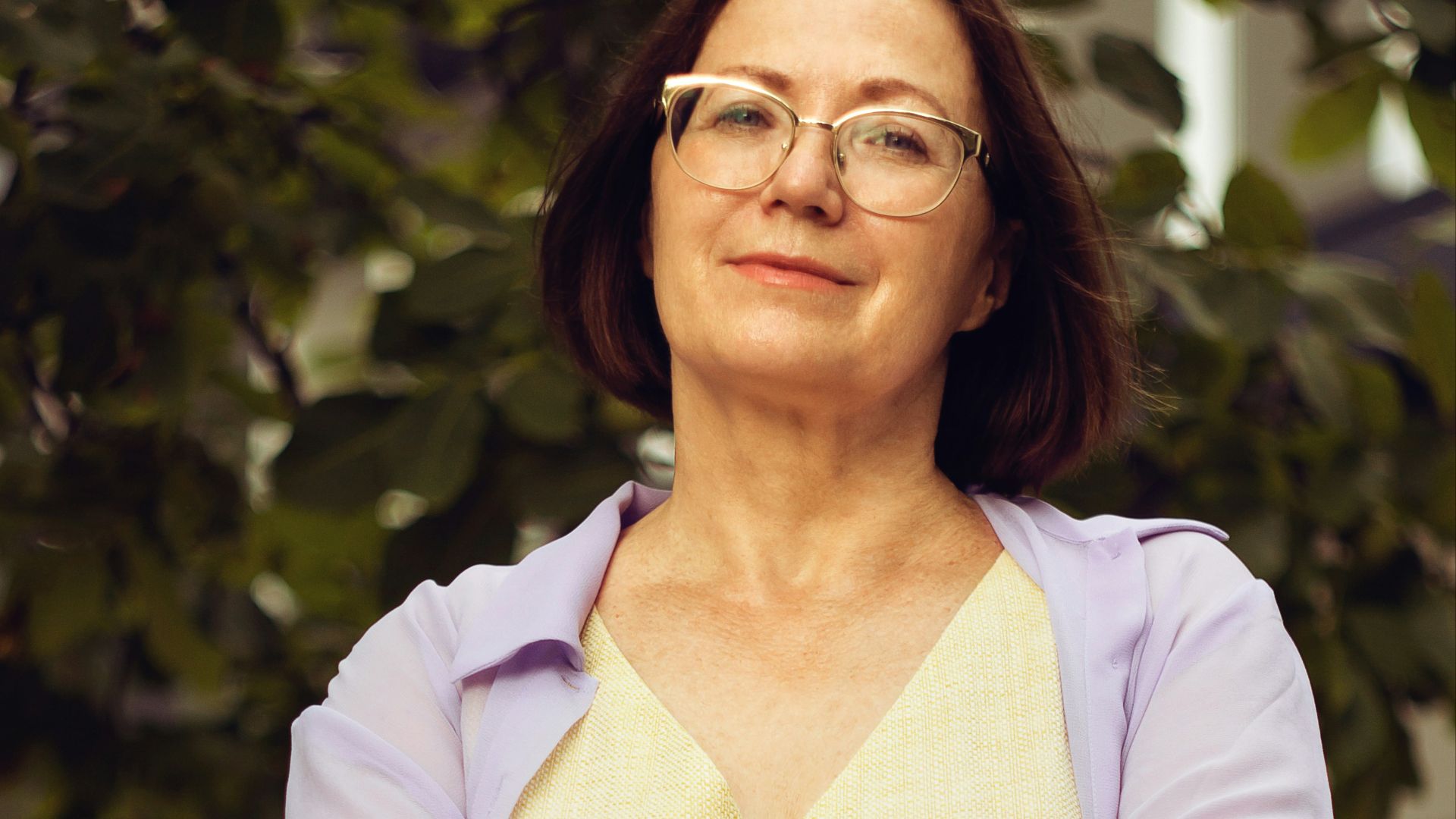 woman in white long sleeve shirt smiling