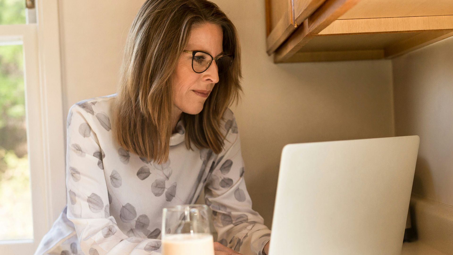 woman using her MacBook Pro inside white room