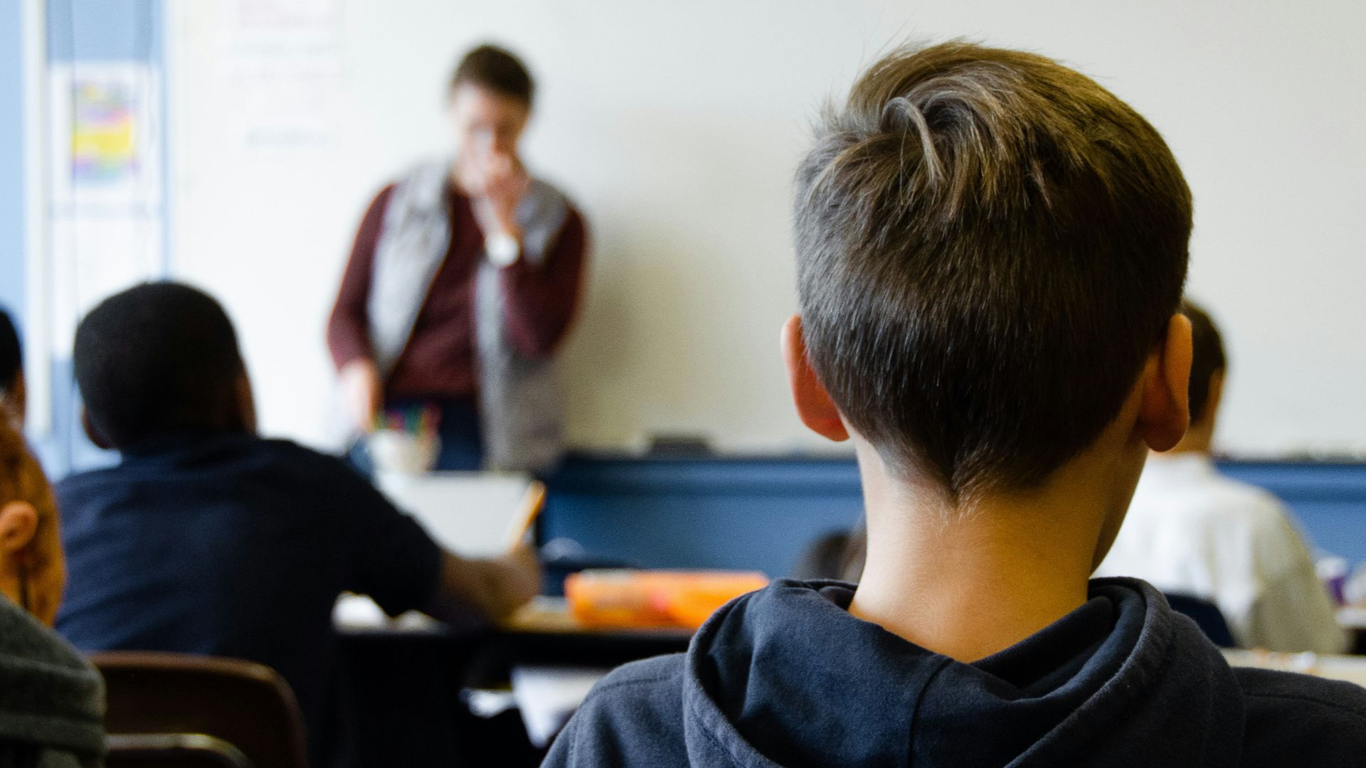boy in black hoodie sitting on chair