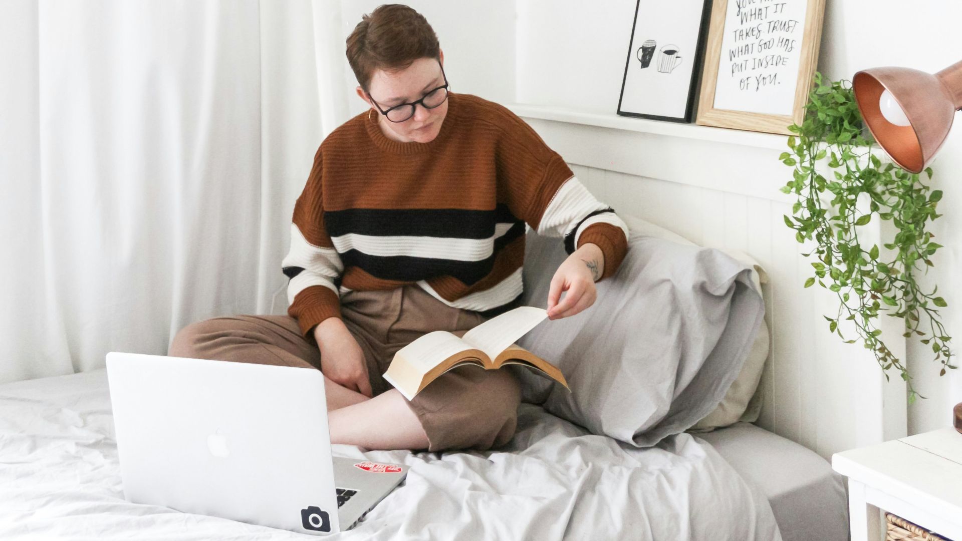 woman sitting on bed inside room