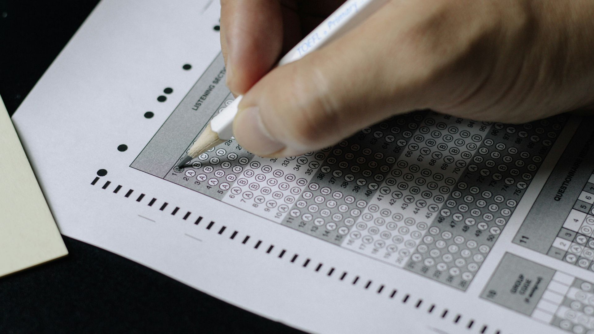 person writing on white paper