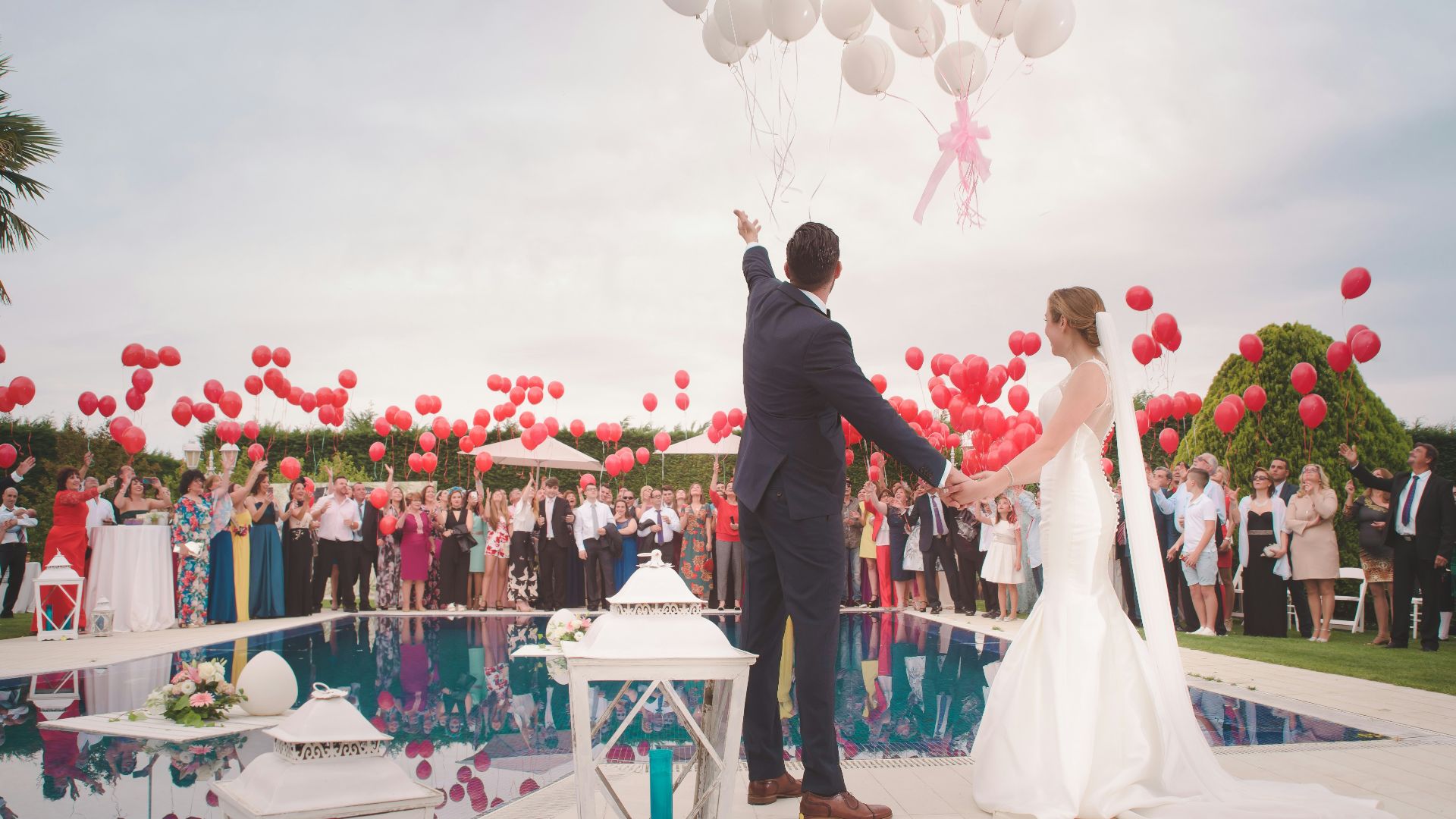 photo of a man and woman newly wedding holding a balloons