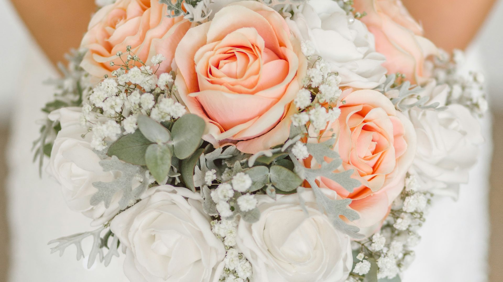 woman holding white and pink rose flower bouquet