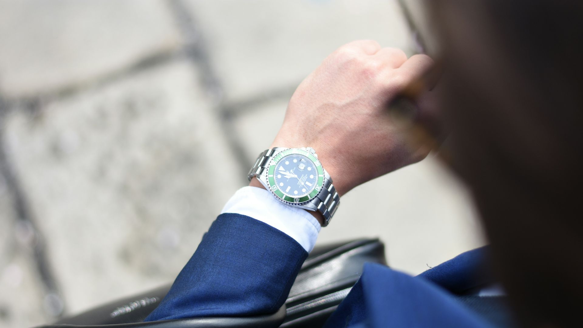 person looking at silver-colored analog watch