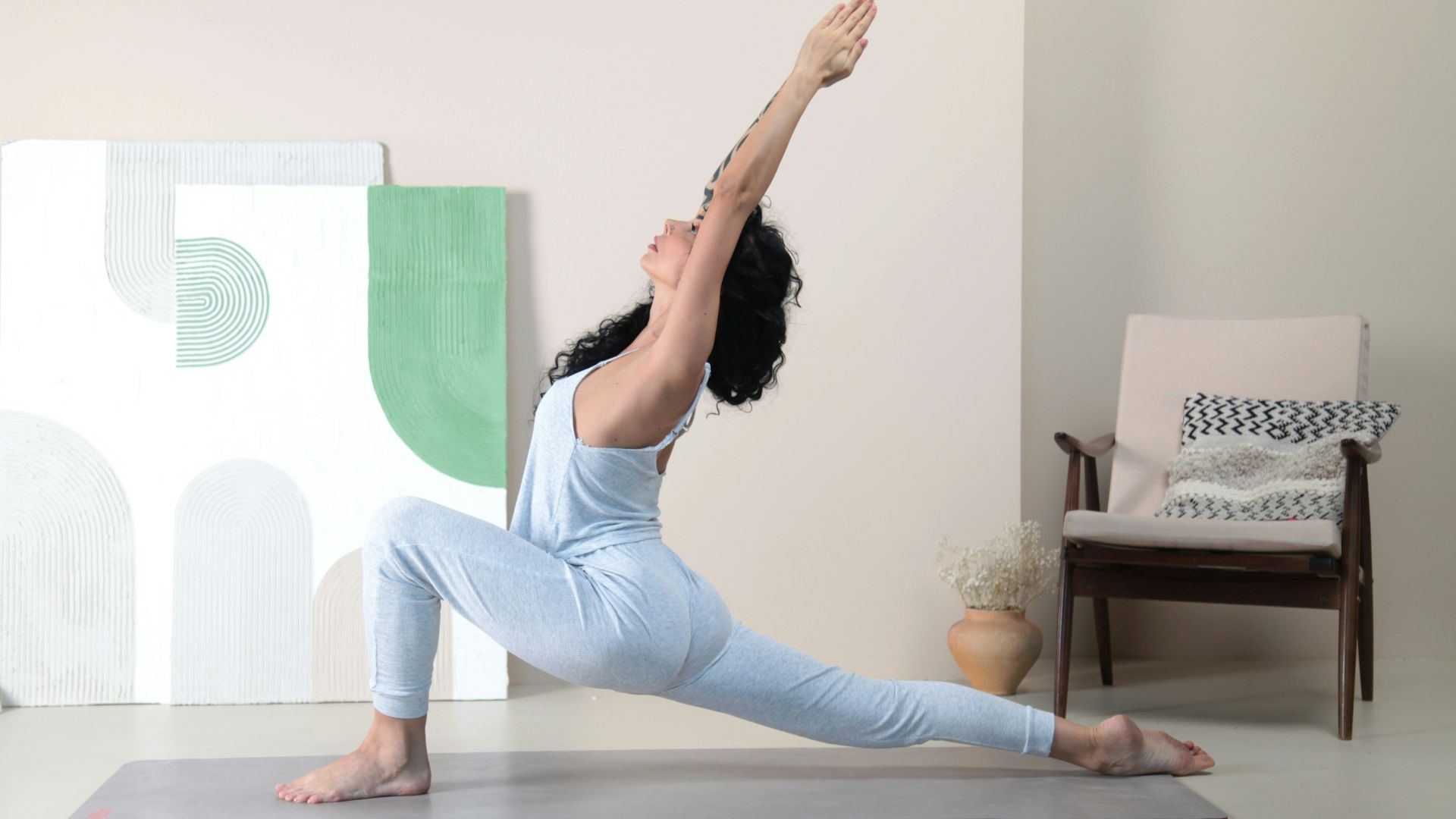 a woman doing a yoga pose in a room