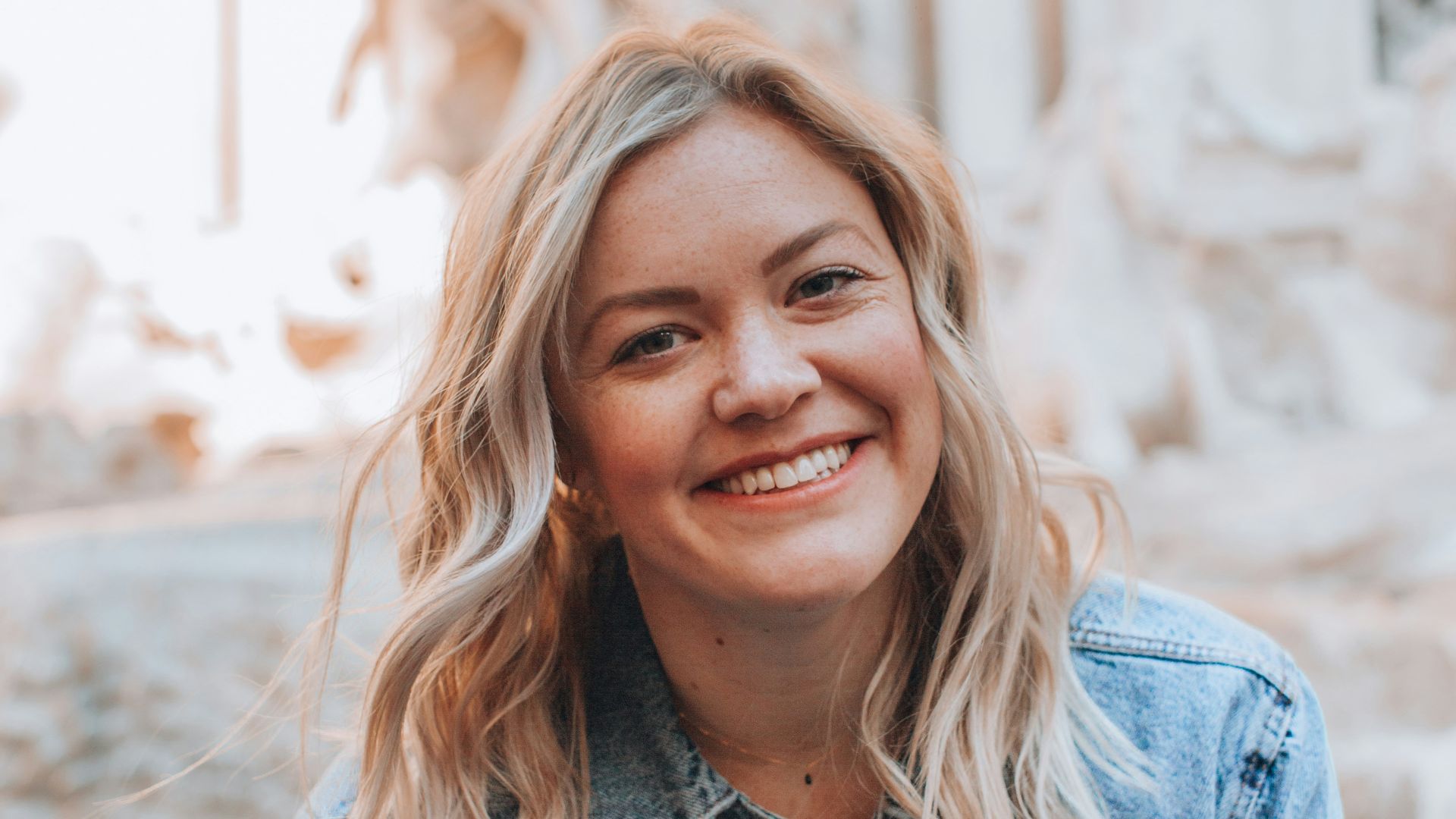 woman smiling wearing denim jacket