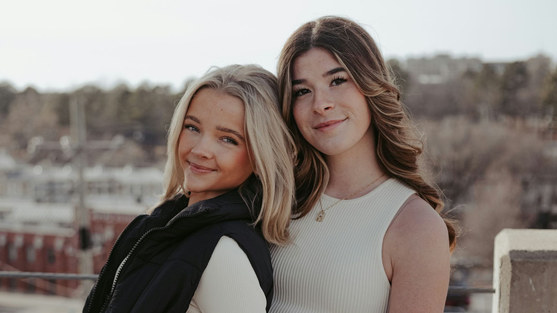 two beautiful women standing next to each other